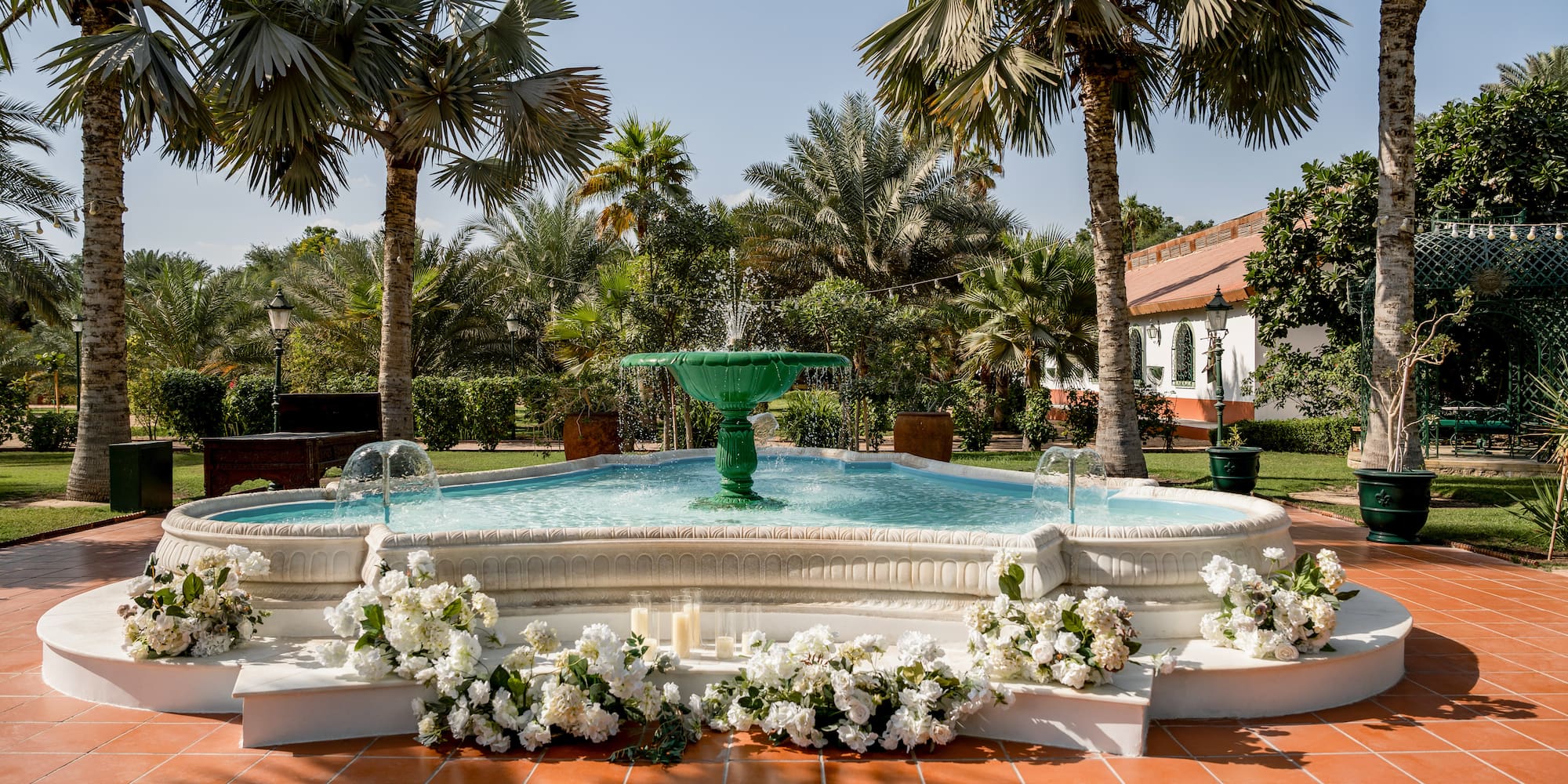 a fountain with flowers around it