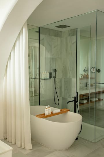 a bathroom with a tub and shower