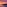 Vibrant sunset over beach with rows of umbrellas and lounge chairs.