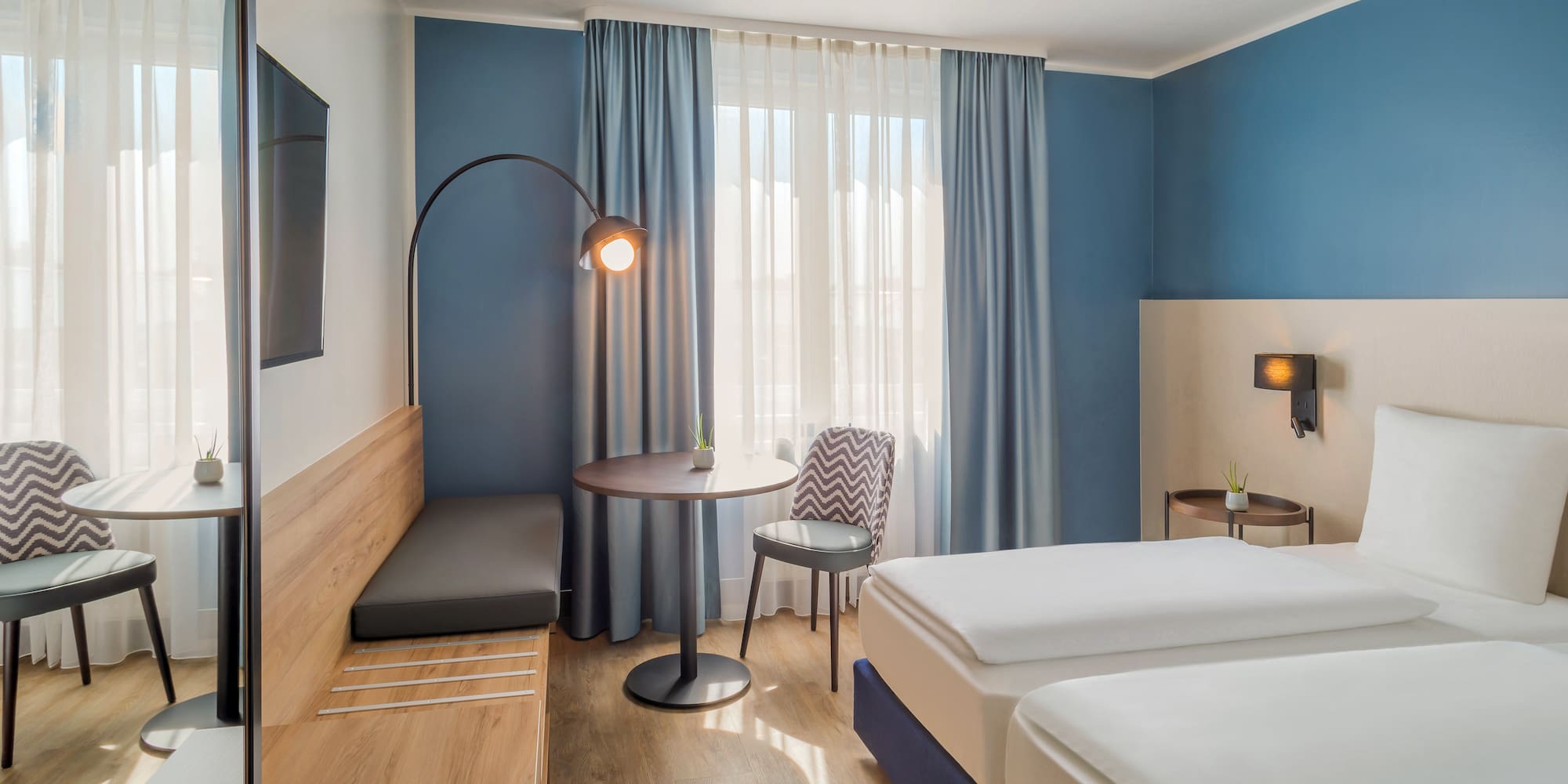 a room with two beds and a table