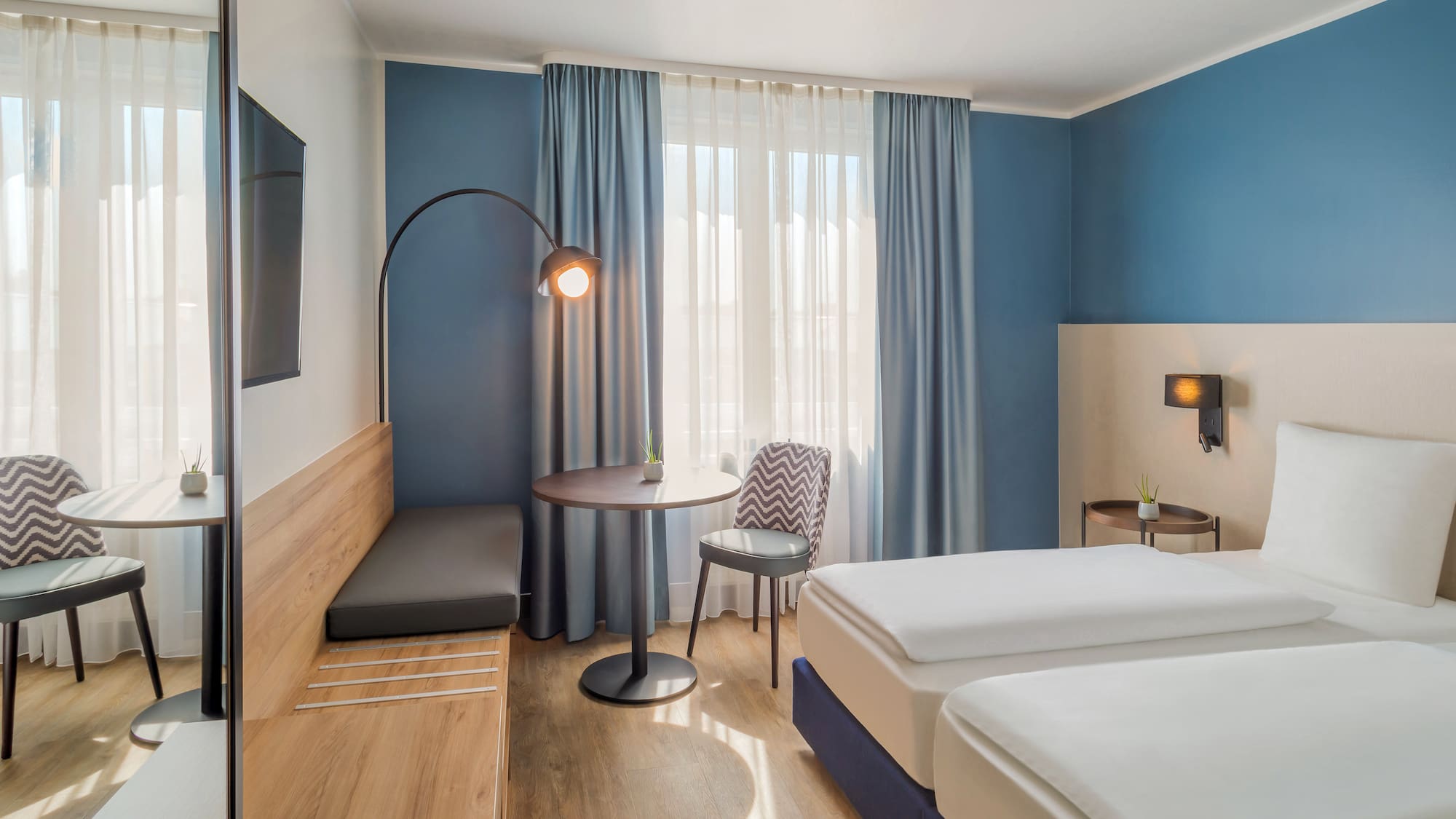 a room with two beds and a table