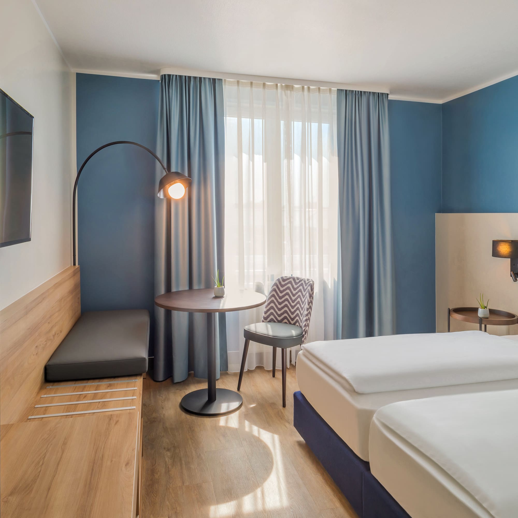 a room with two beds and a table