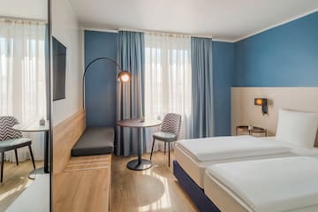a room with two beds and a table