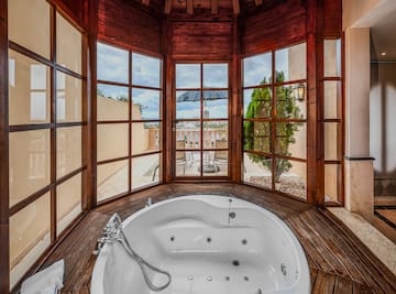 a large tub in a room with windows