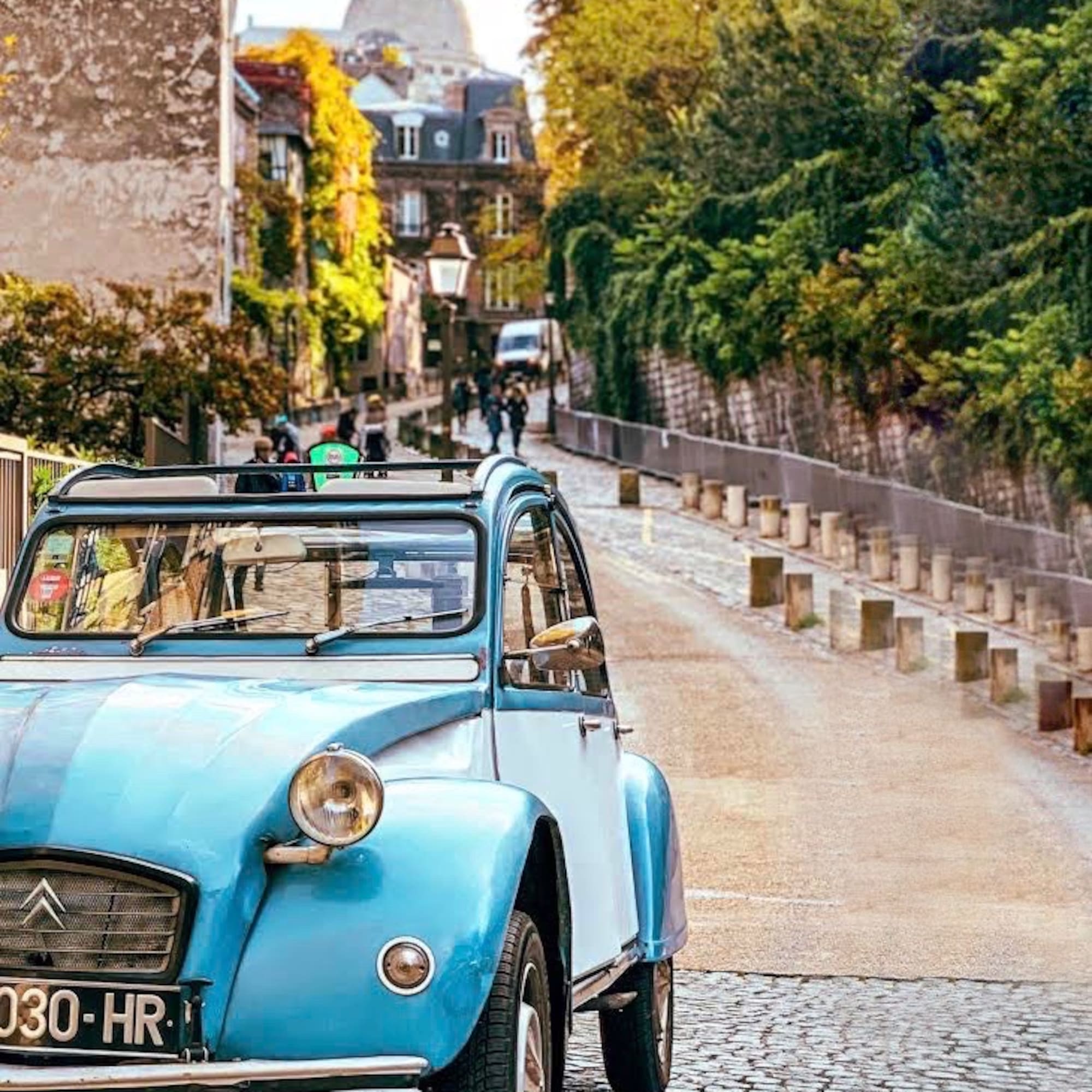 a blue car on a street
