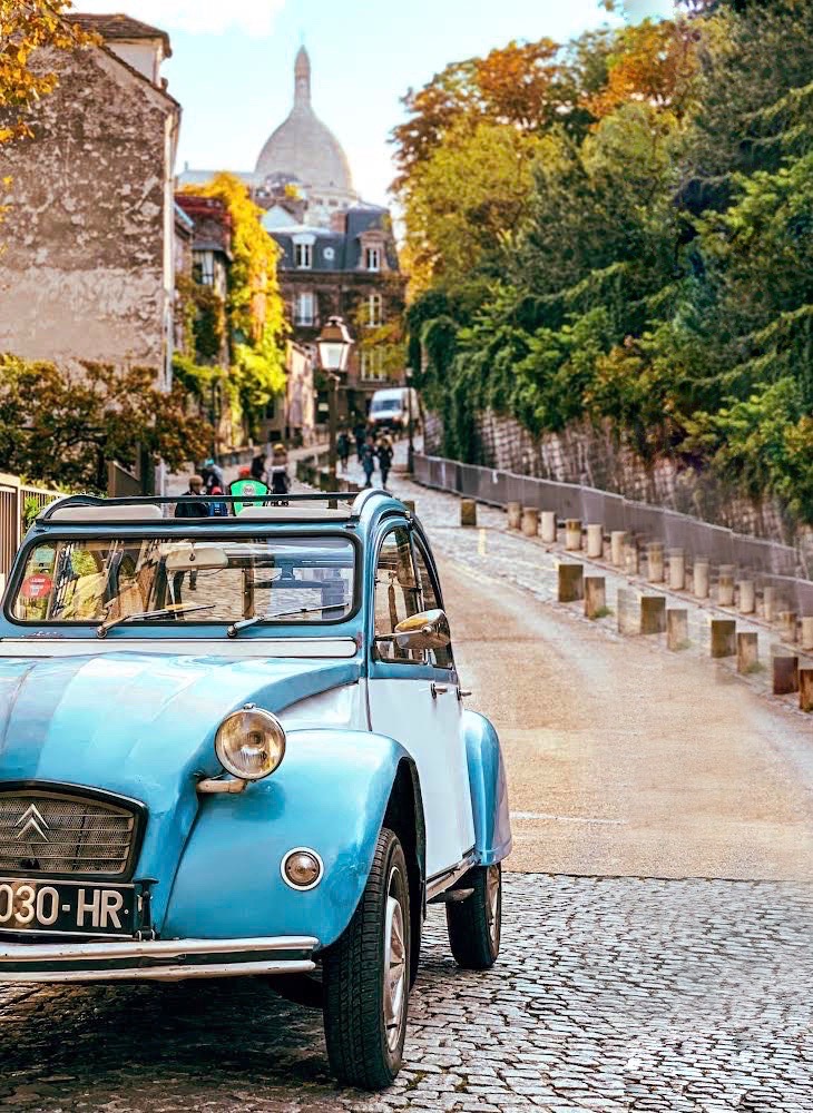 a blue car on a street