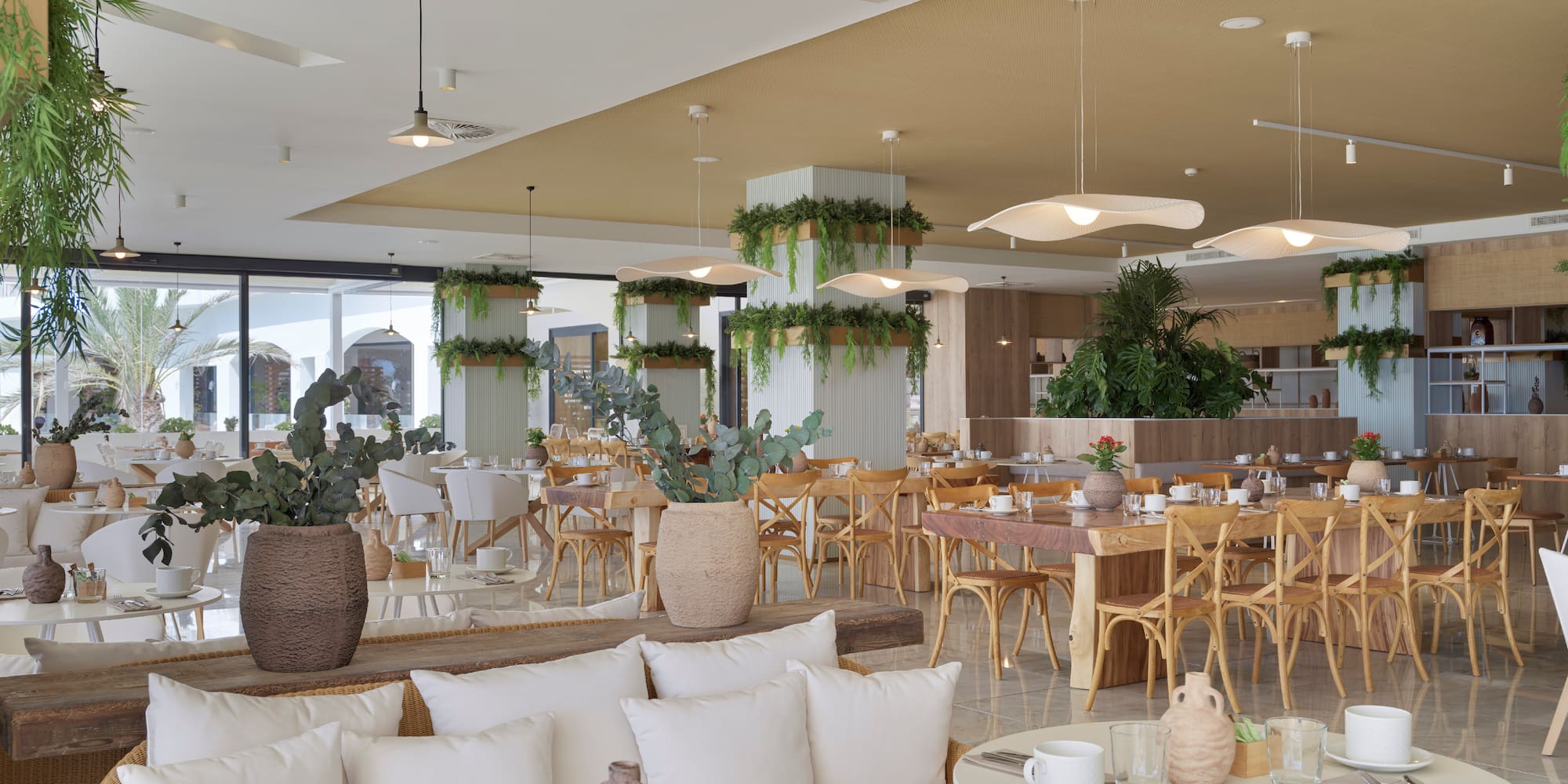 a room with tables and chairs and plants