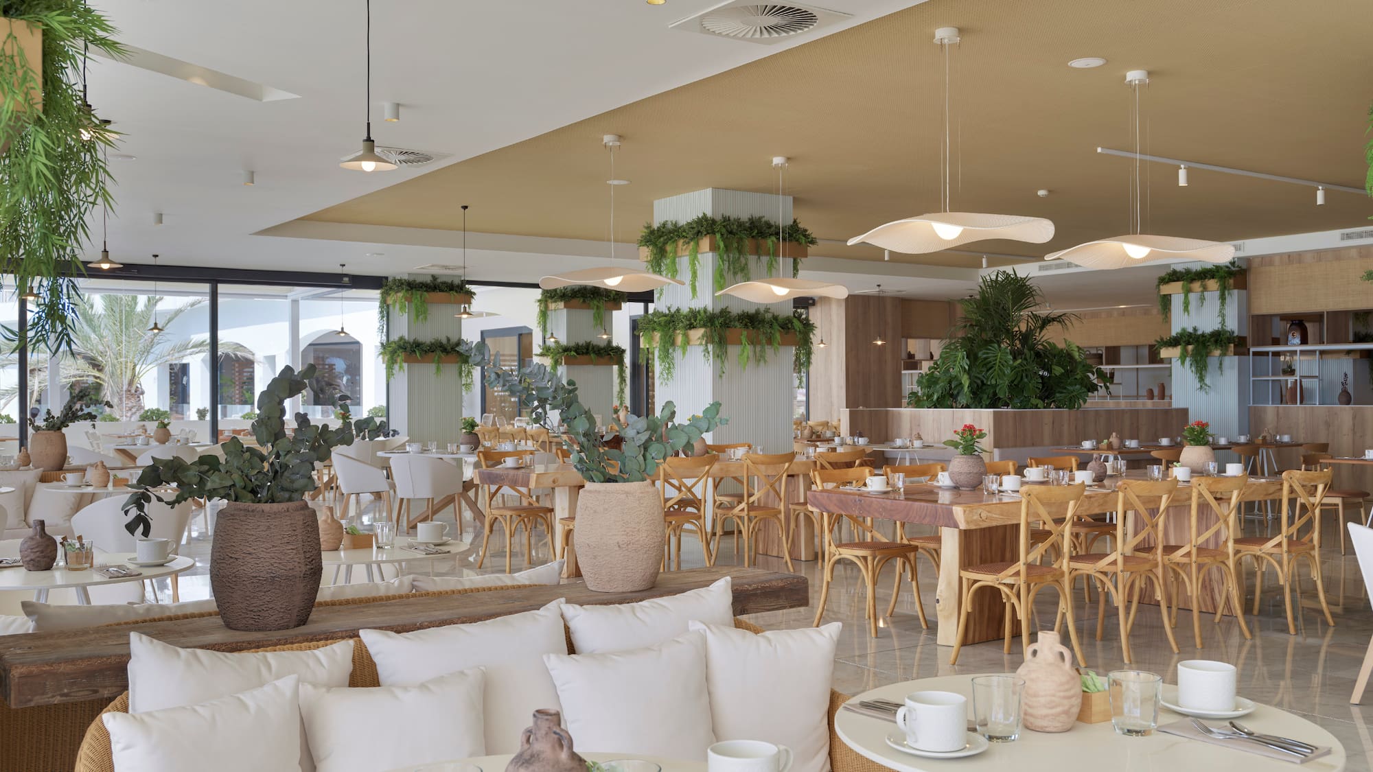 a room with tables and chairs and plants