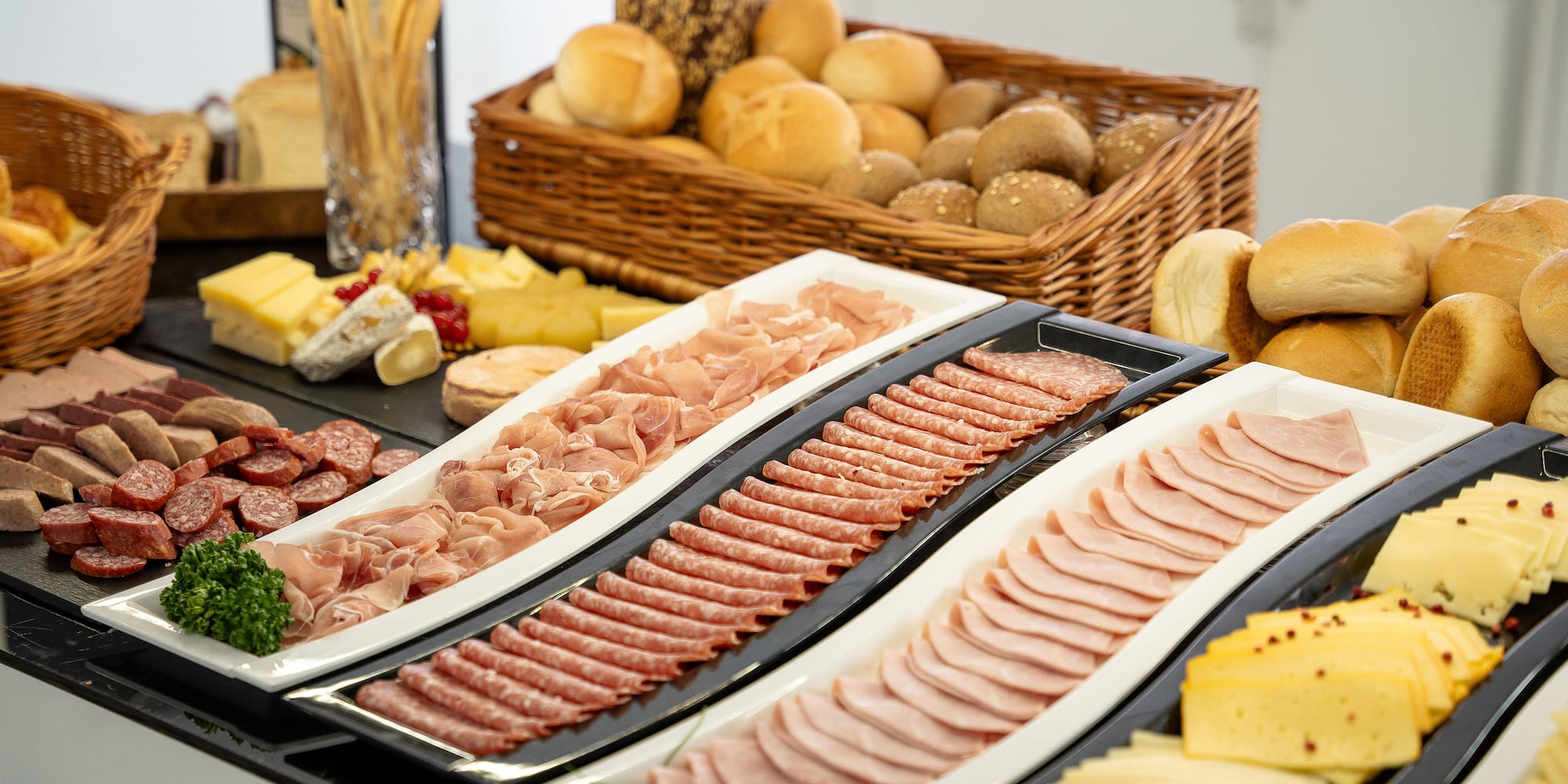 a trays of meat and cheese on a table