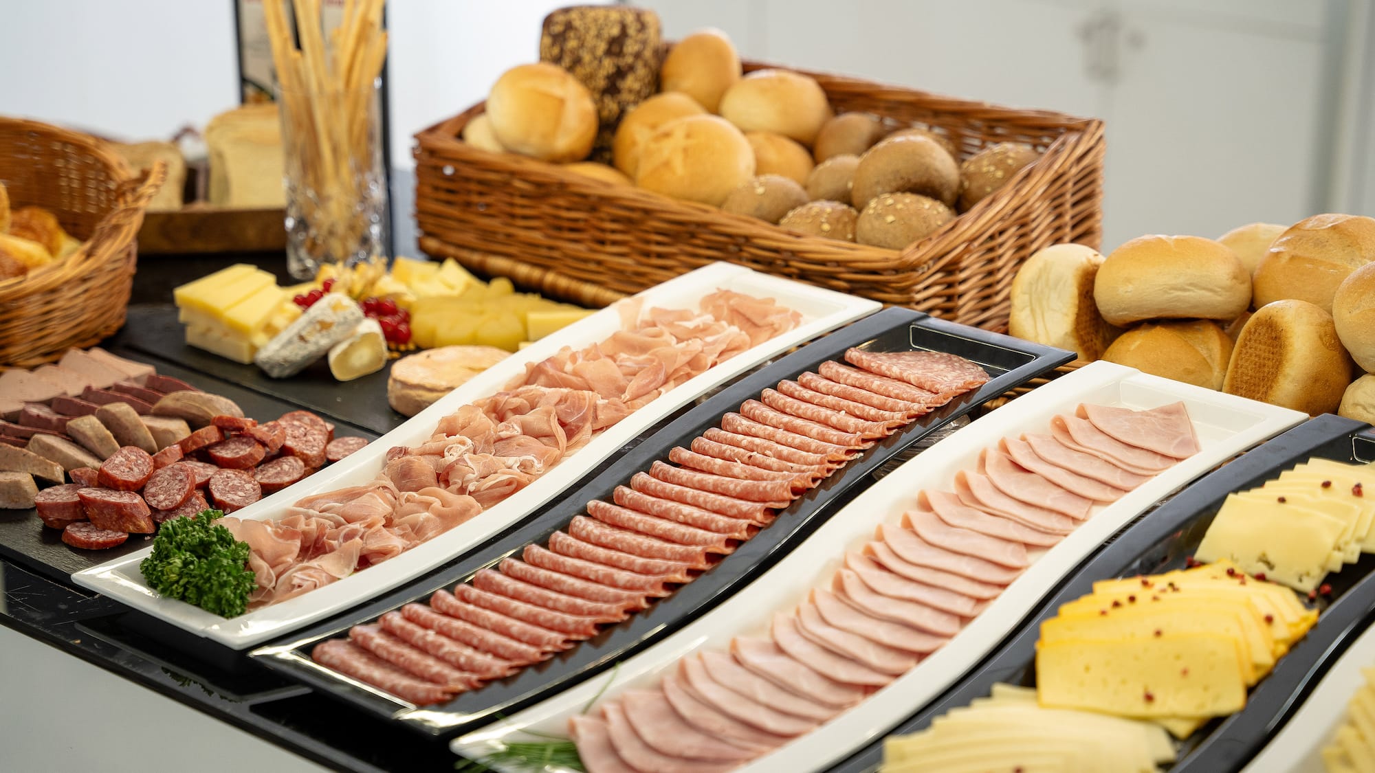 a trays of meat and cheese on a table