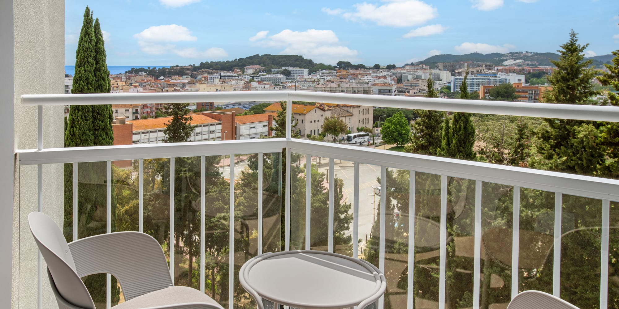 a balcony with chairs and a table