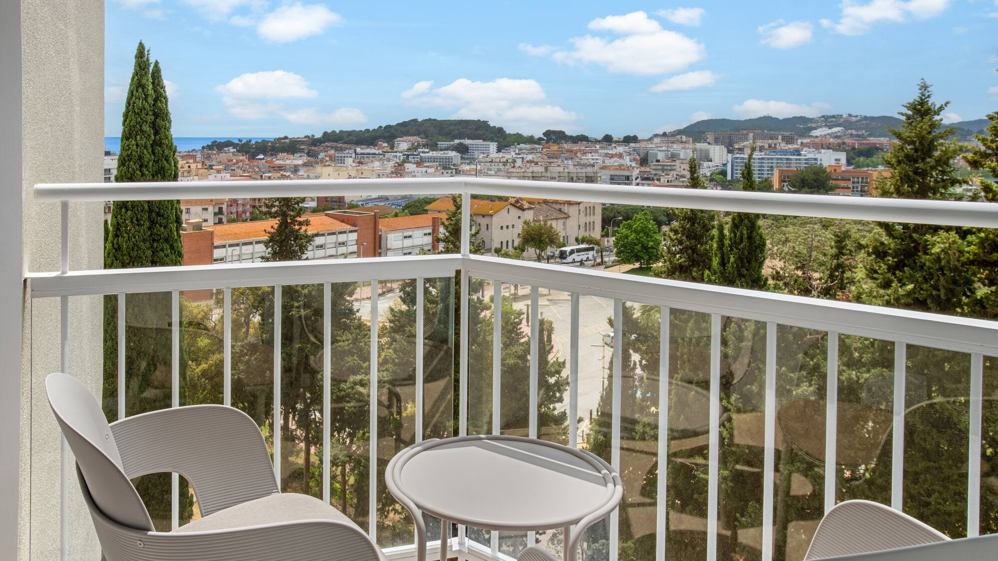 a balcony with chairs and a table