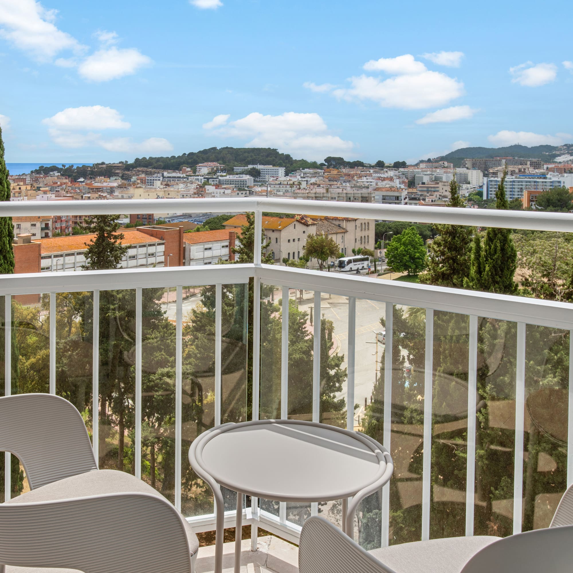 a balcony with chairs and a table