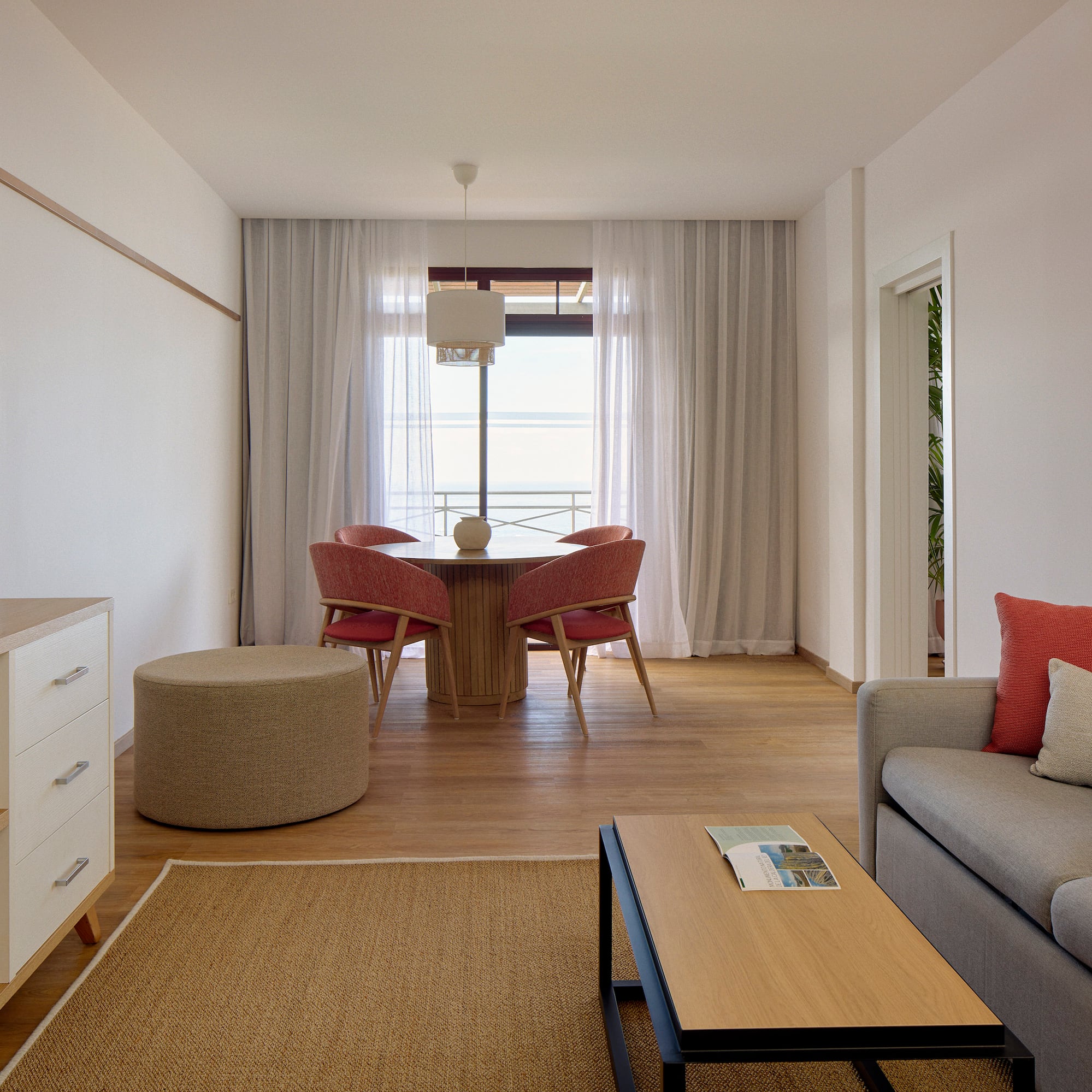 a living room with a table and chairs