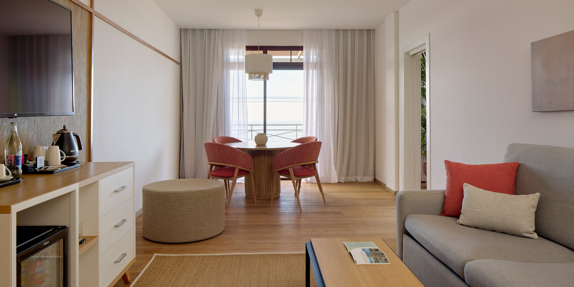 a living room with a table and chairs