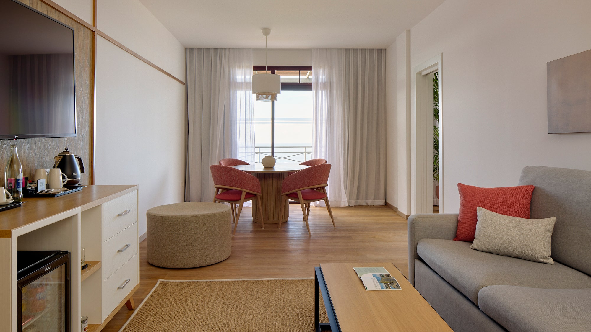 a living room with a table and chairs