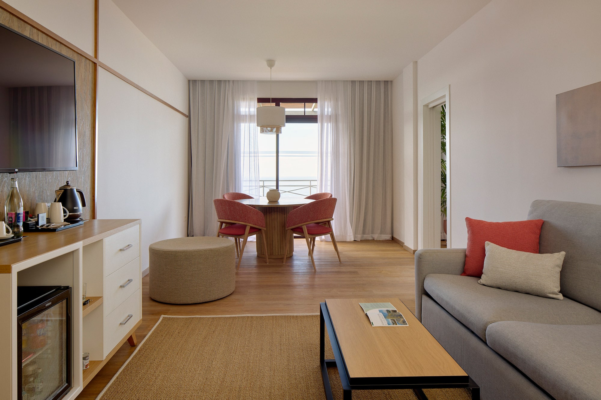 a living room with a table and chairs