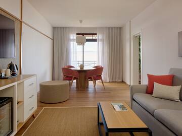 a living room with a table and chairs