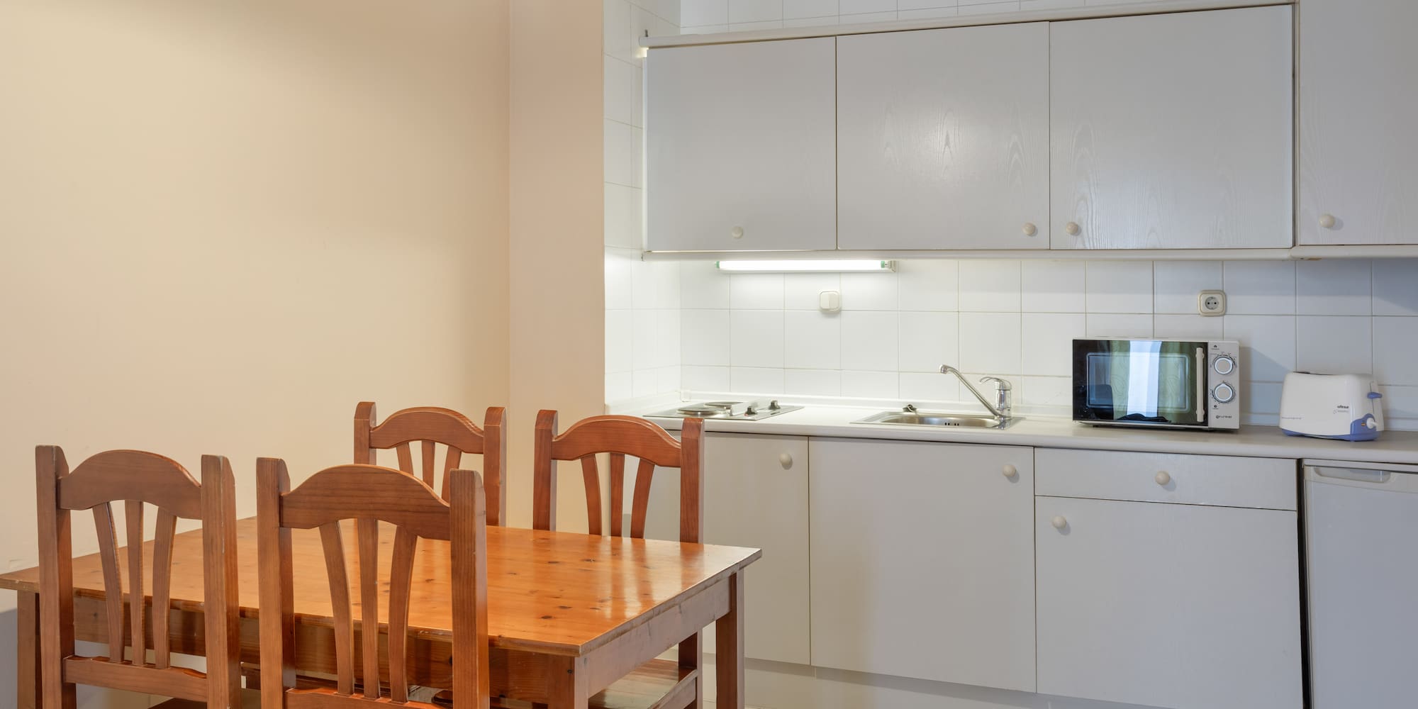 a kitchen with a table and chairs