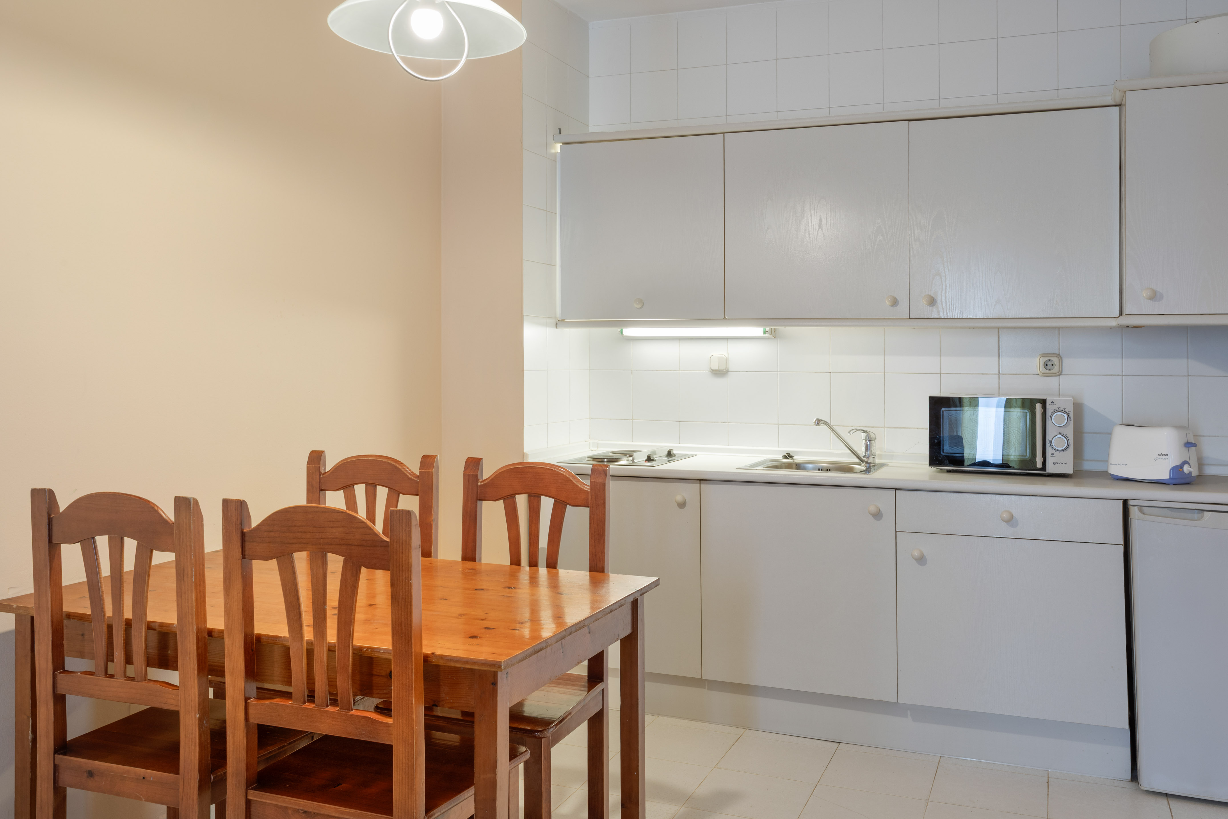 a kitchen with a table and chairs
