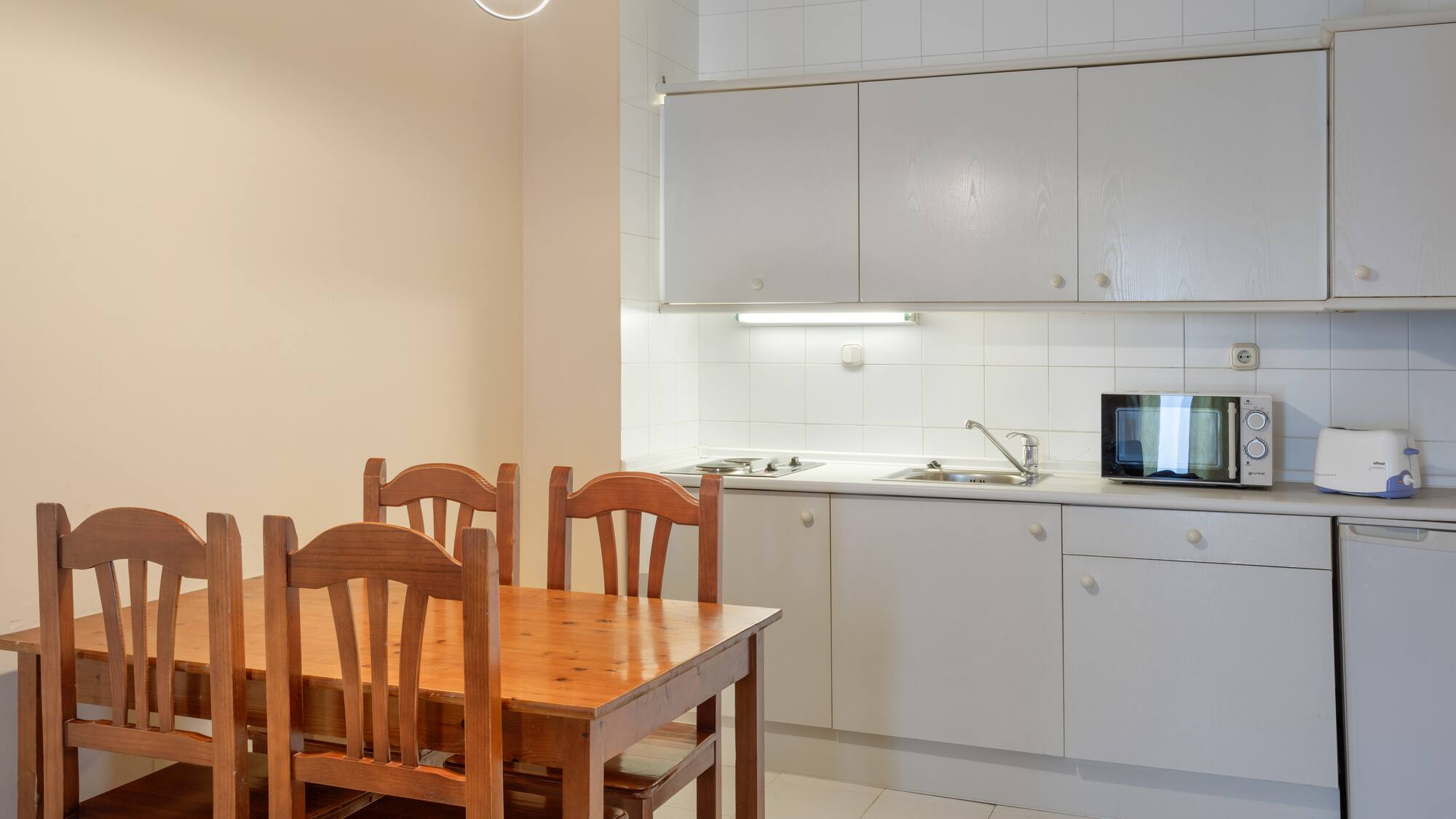 a kitchen with a table and chairs
