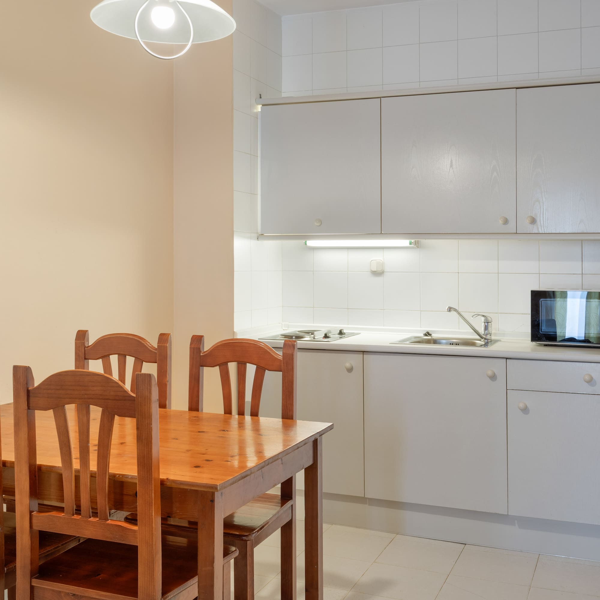 a kitchen with a table and chairs