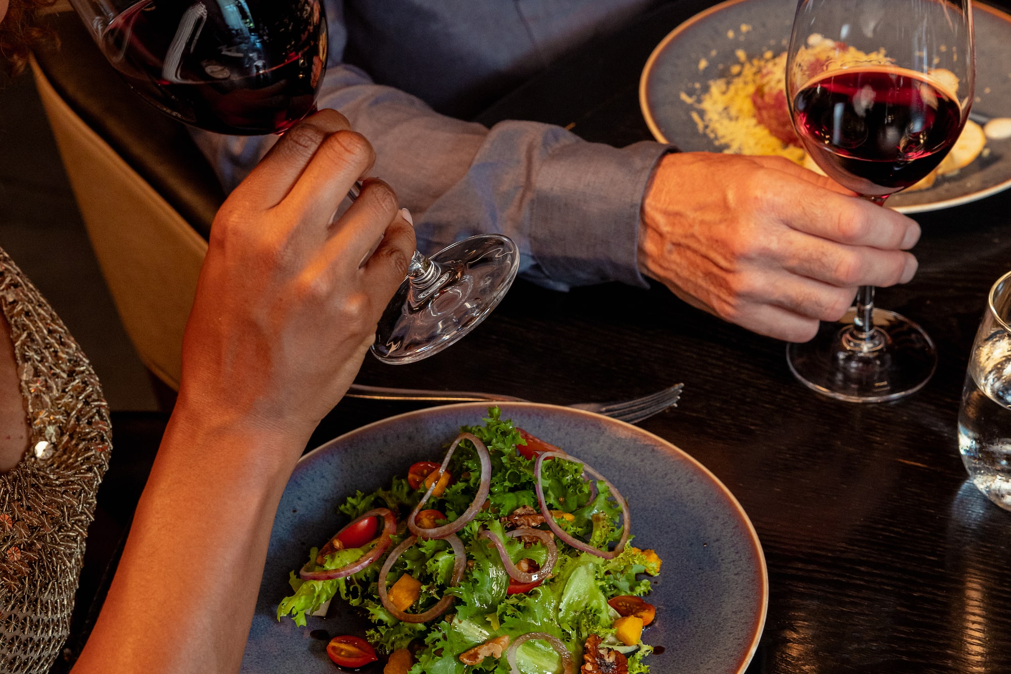 a group of people sitting at a table with wine glasses