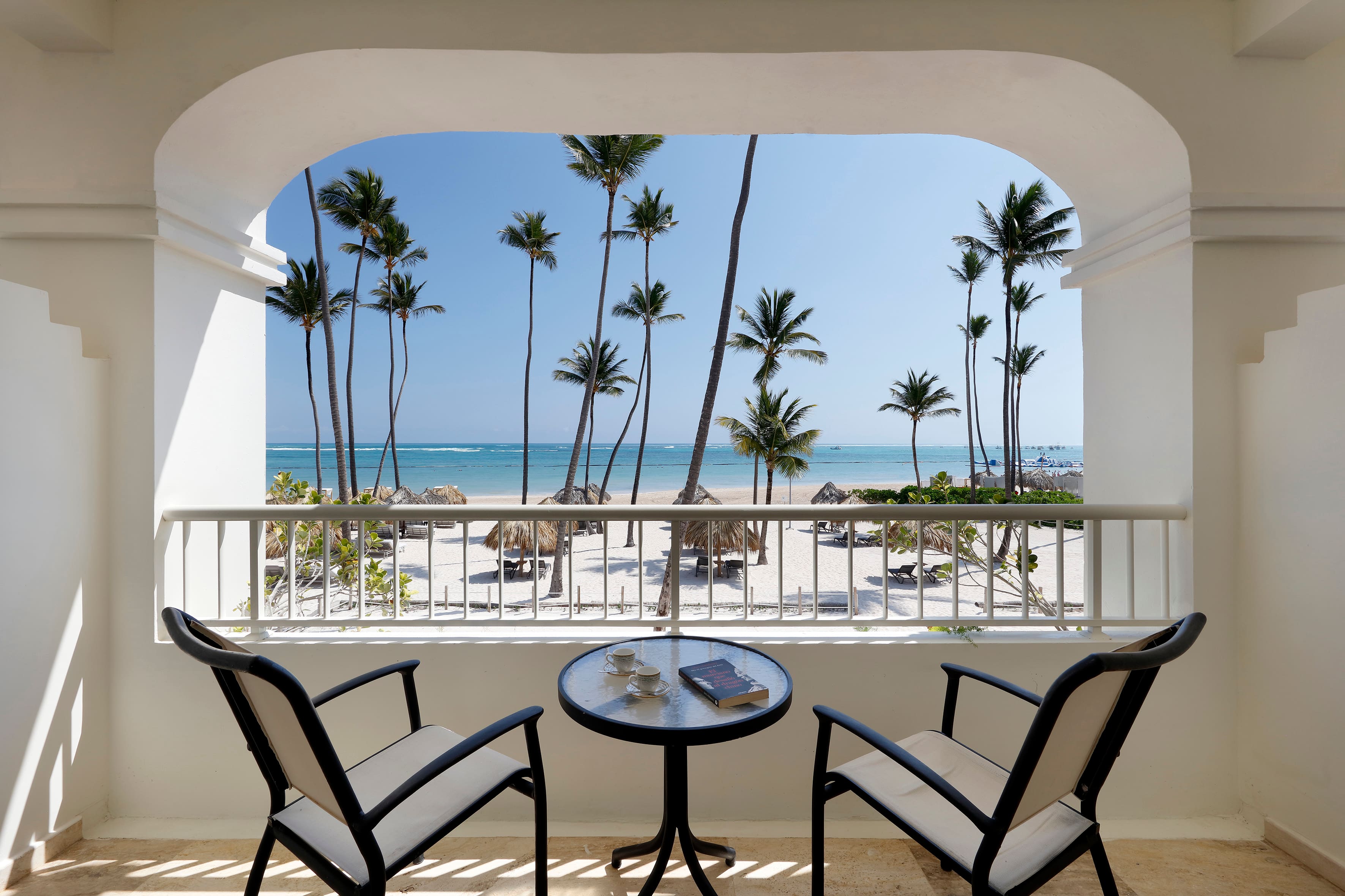 The view from the suite's balcony: beach, palm trees and turquoise water