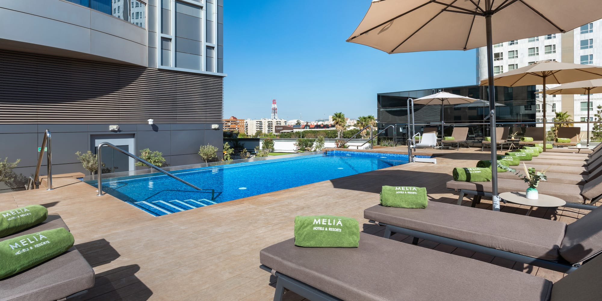 a pool with lounge chairs and umbrellas