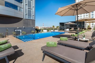 a pool with lounge chairs and umbrellas