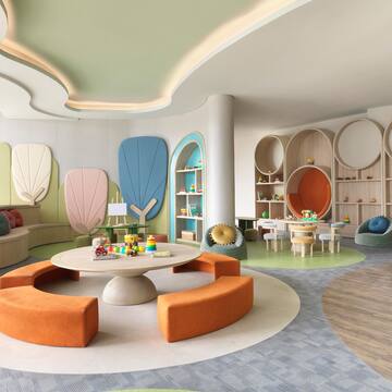 a room with a round table and colorful chairs