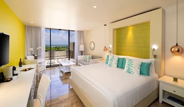 a room with a bed and a table and chairs