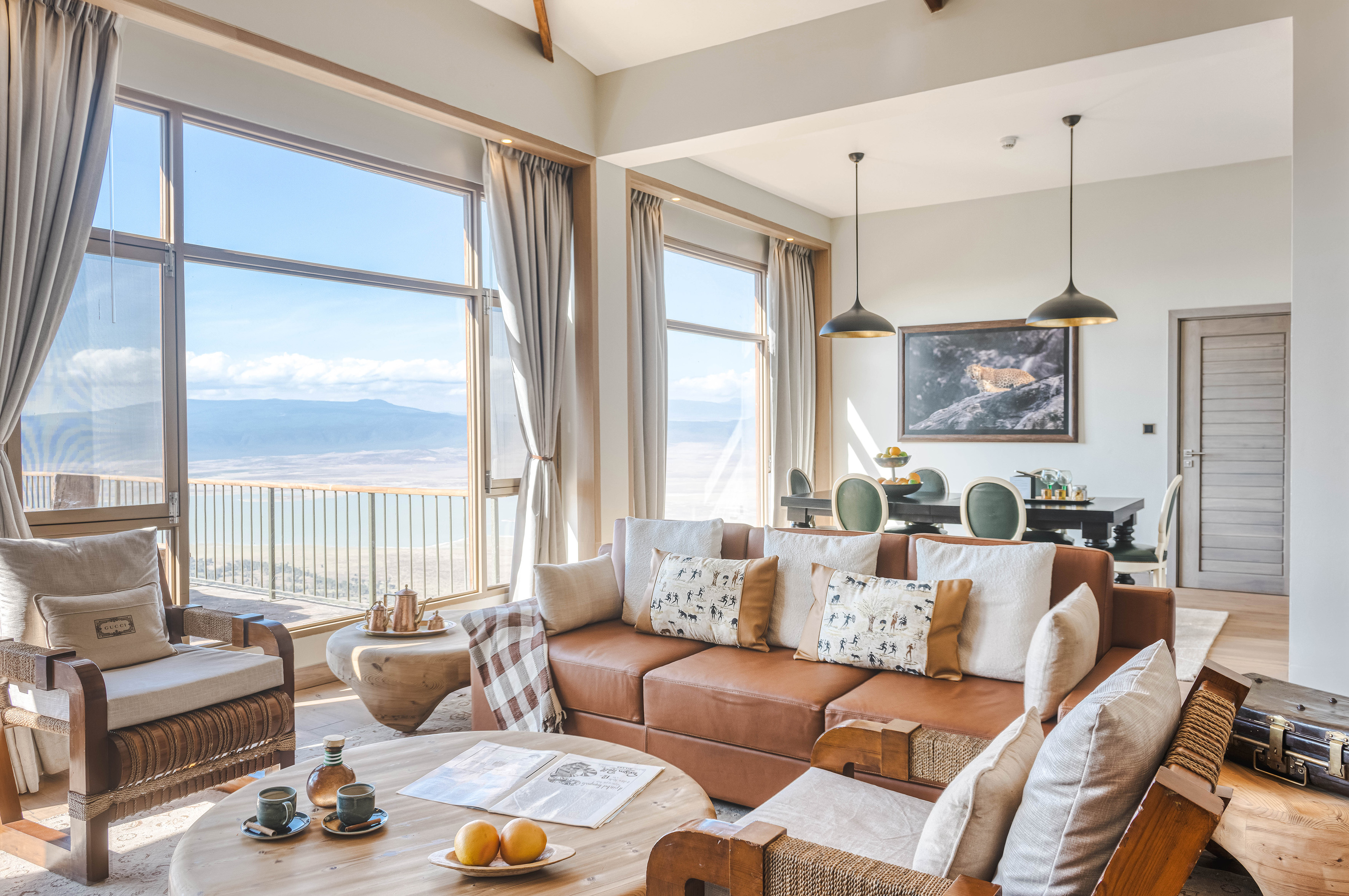 Luxury safari lodge living room with panoramic valley view and modern decor.