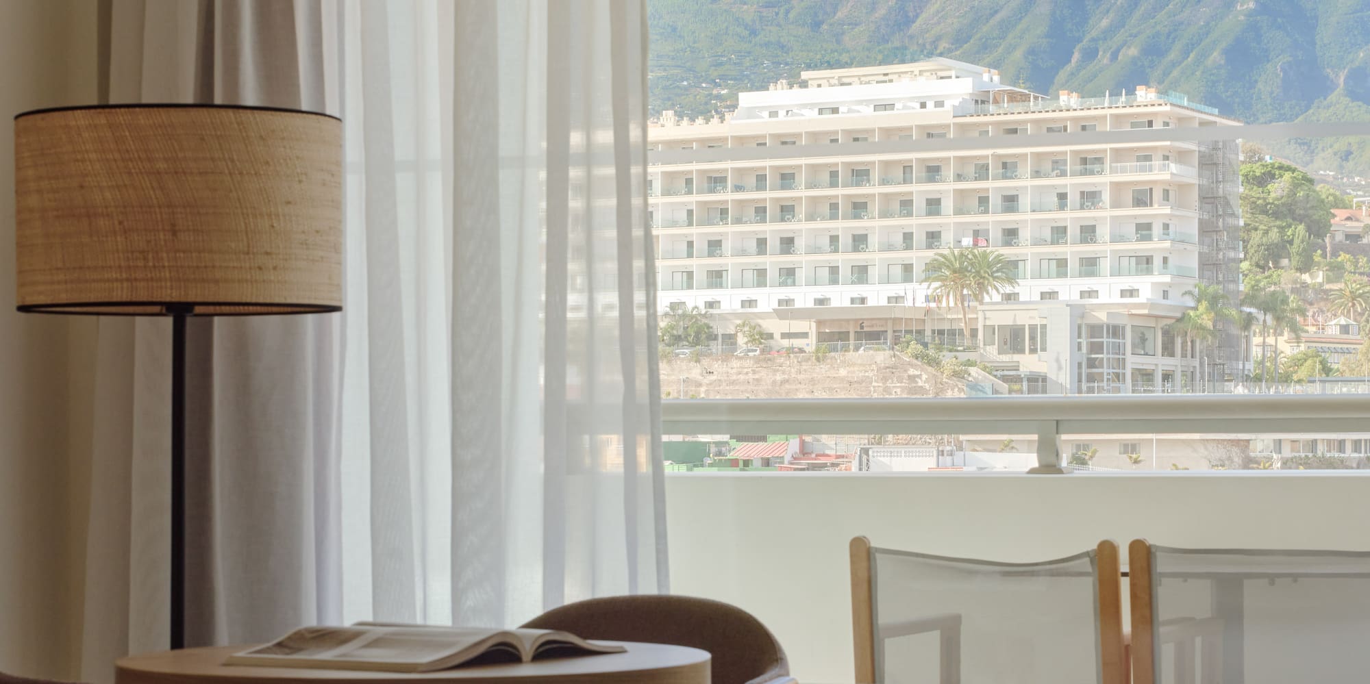 a room with a table and chairs and a lamp