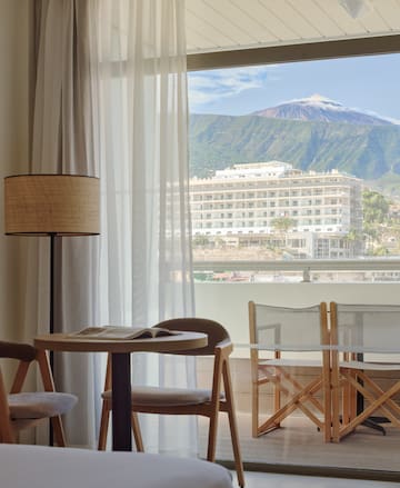 a room with a table and chairs and a lamp