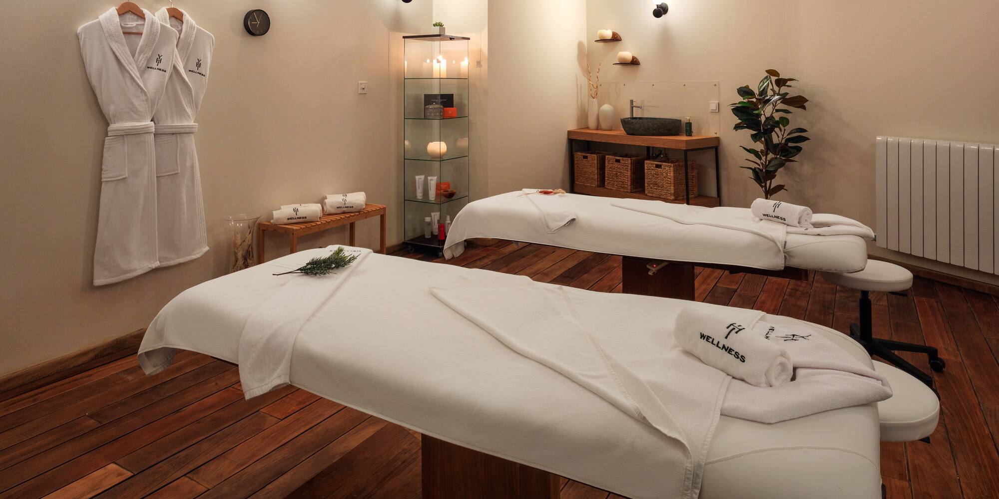 a room with white beds and towels