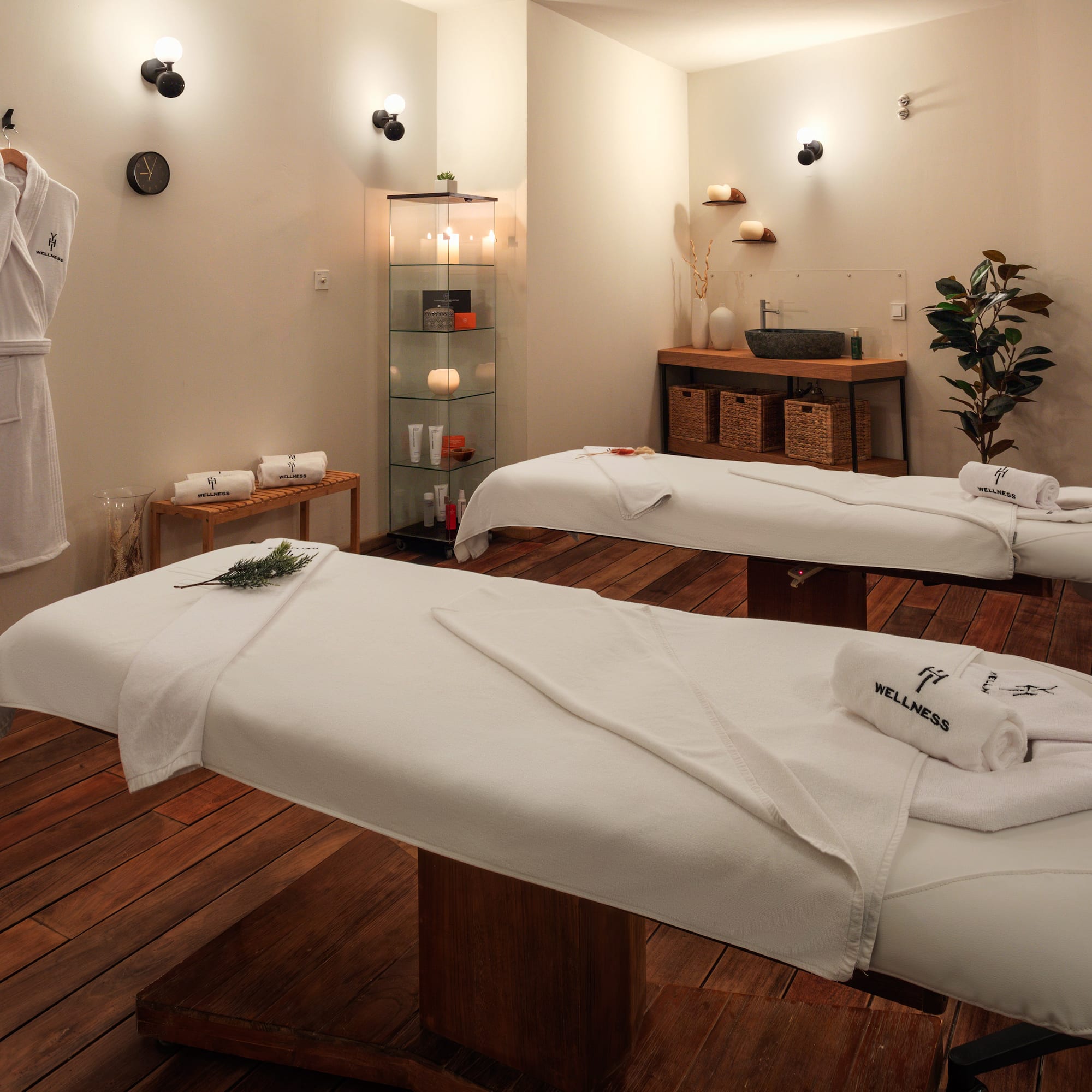 a room with white beds and towels