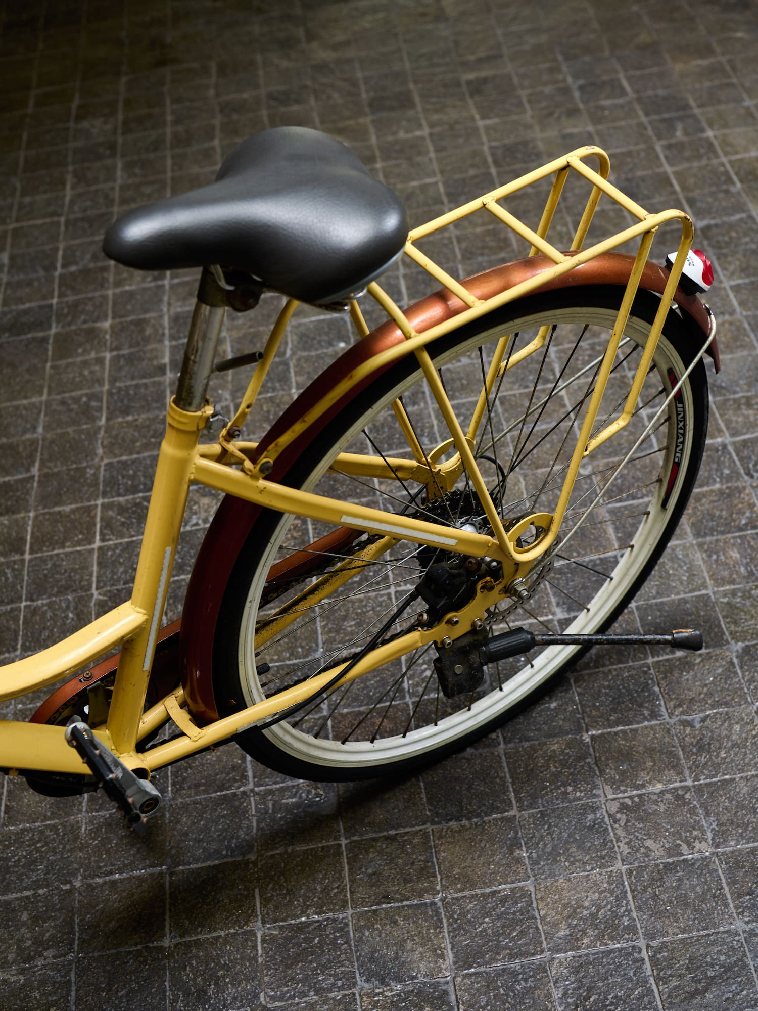 a yellow bicycle with a black seat