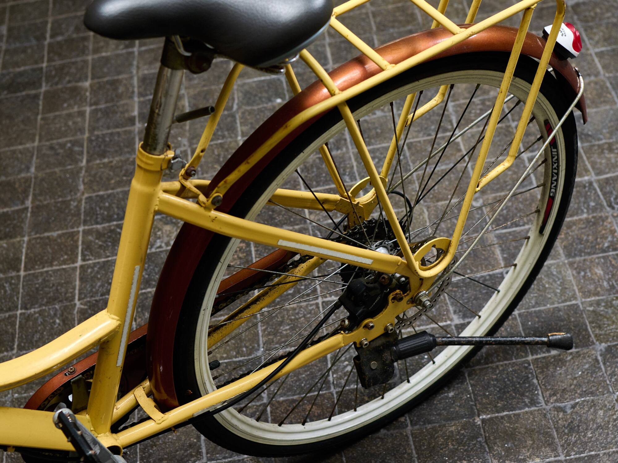 a yellow bicycle with a black seat