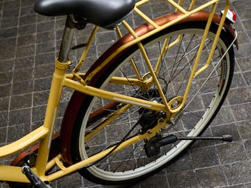 a yellow bicycle with a black seat