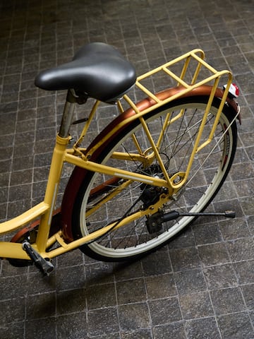 a yellow bicycle with a black seat