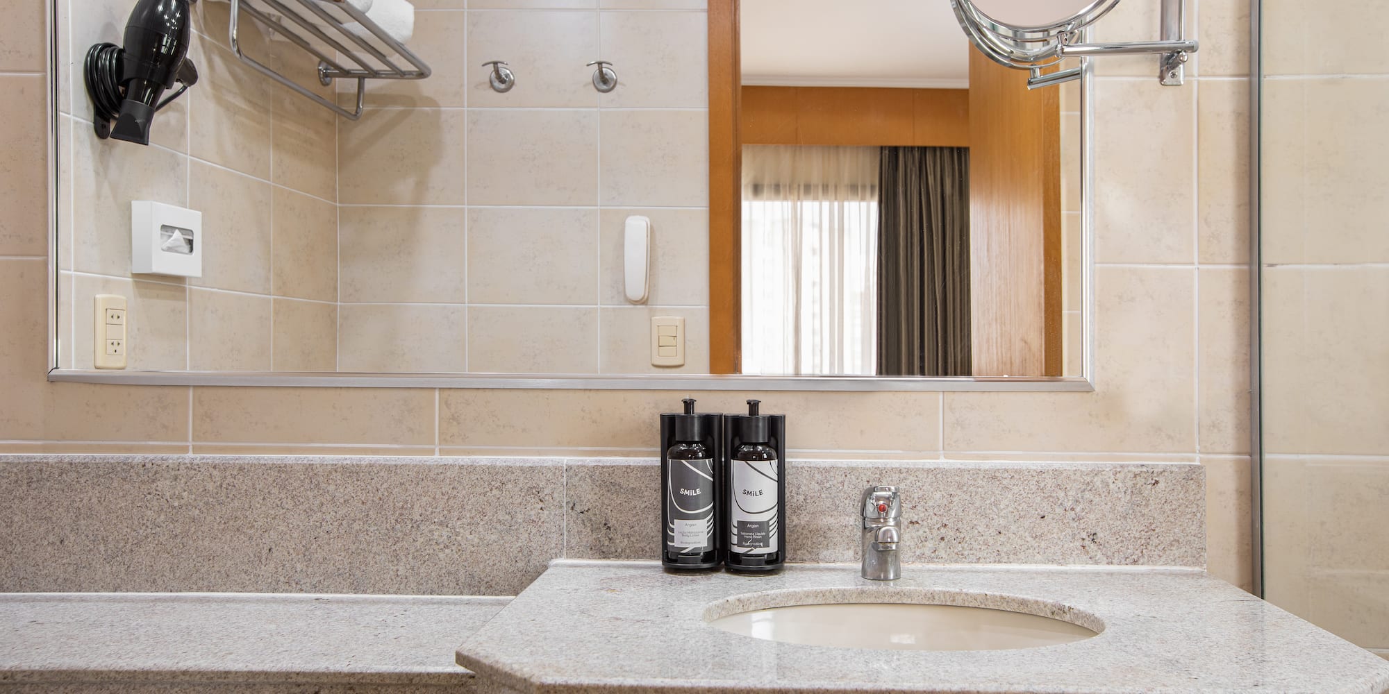 a bathroom with a mirror and a sink