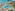 Luxury tropical resort pool, palm trees, sandy beach, and turquoise ocean.