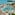 Luxury tropical resort pool, palm trees, sandy beach, and turquoise ocean.
