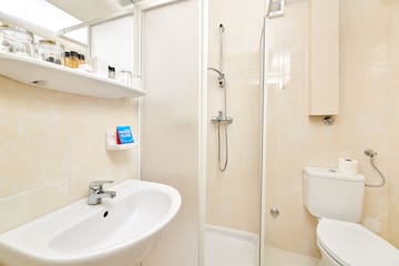 a bathroom with a shower and toilet