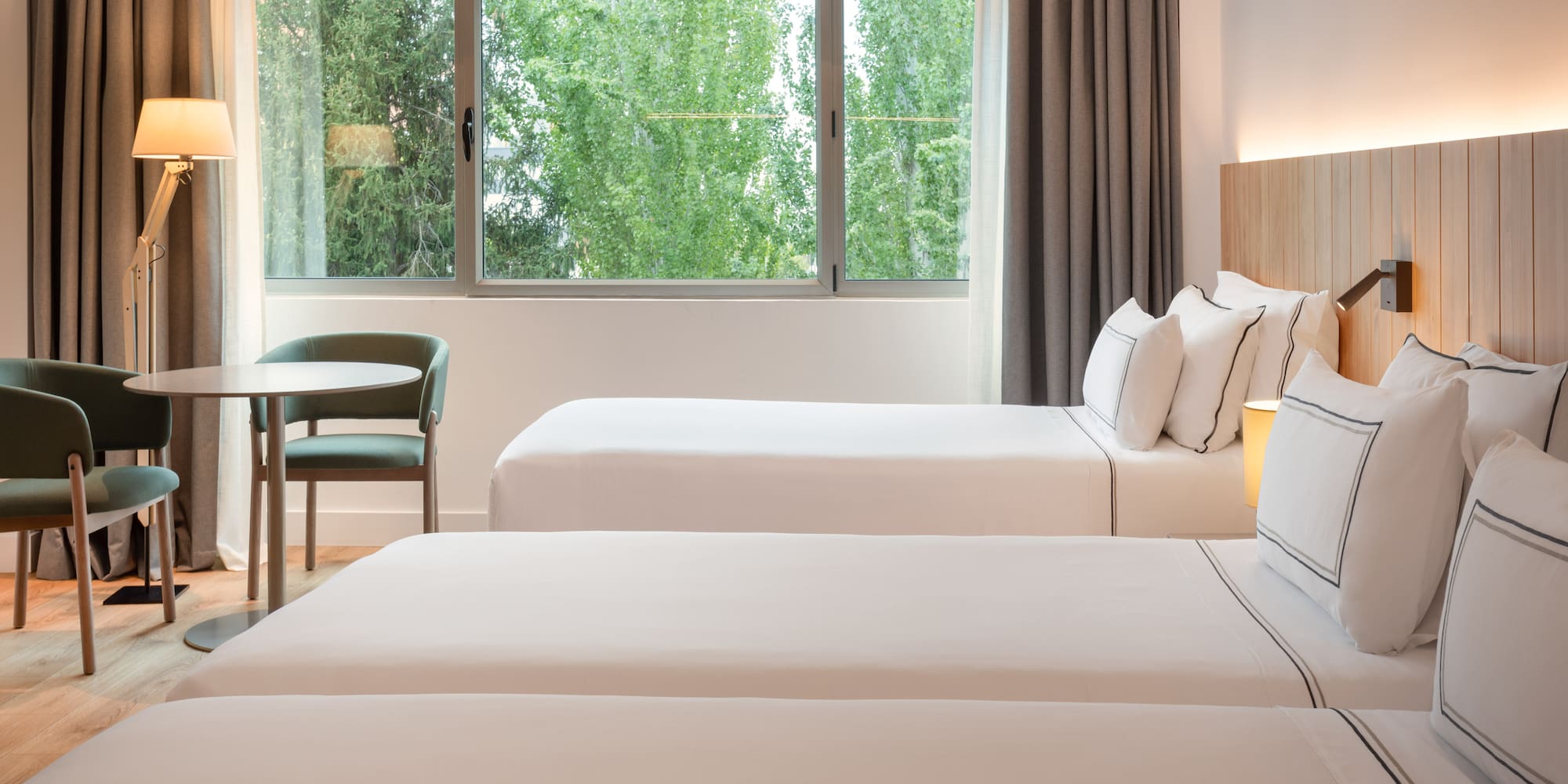 a room with two beds and a table