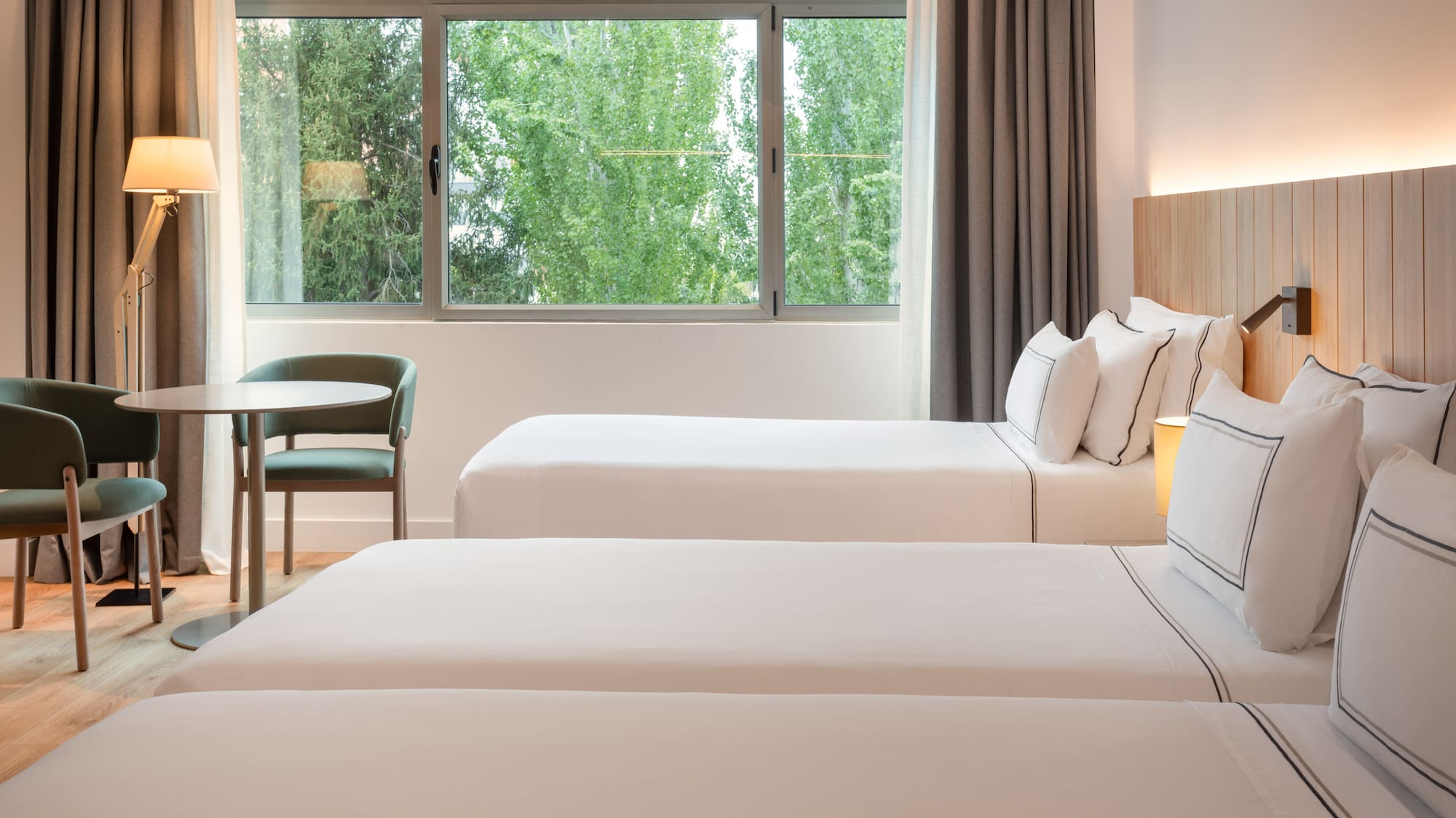 a room with two beds and a table