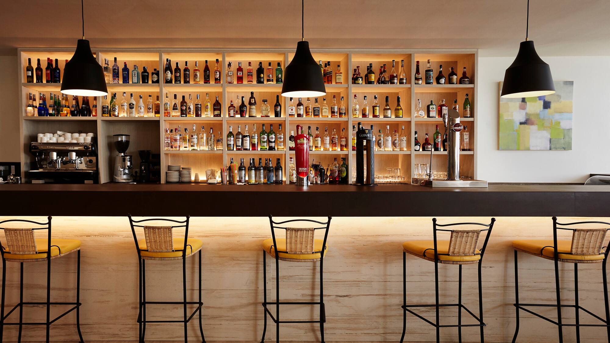a bar with bottles on the shelves