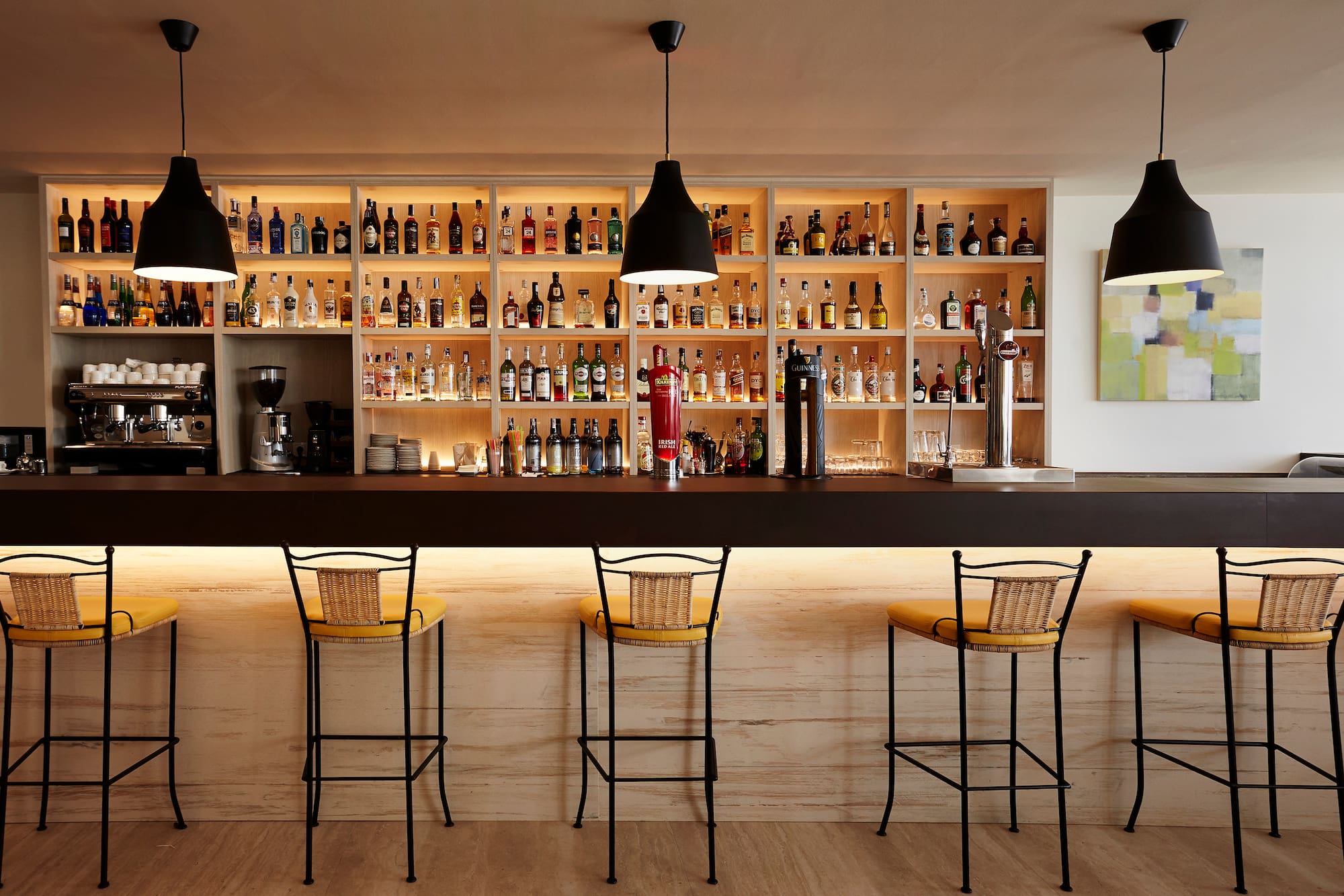 a bar with bottles on the shelves