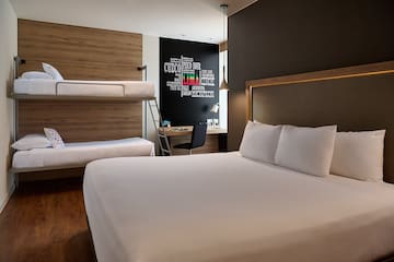 a room with bunk beds and a desk